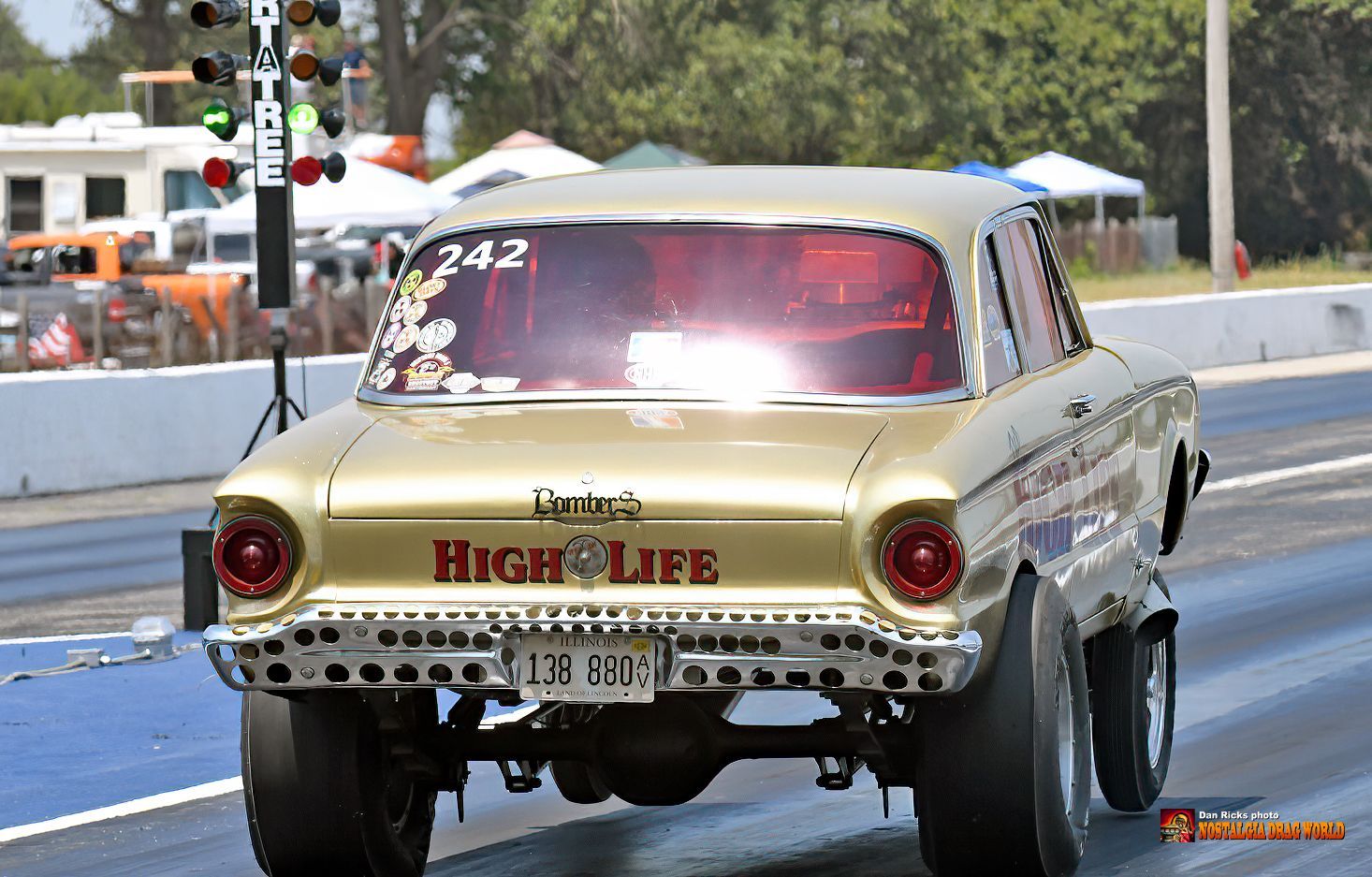 A gold car with the word high life on the back
