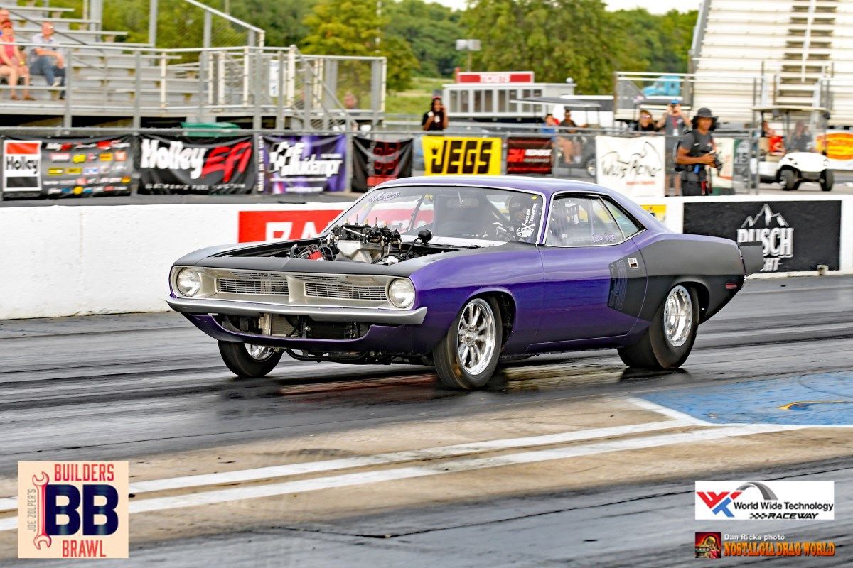 A purple car is on a race track with a sign that says bb on it