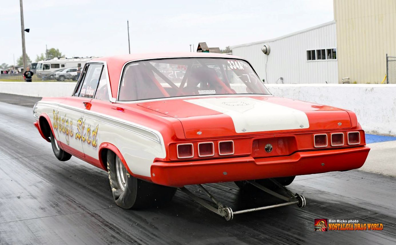 A red and white race car is on a track