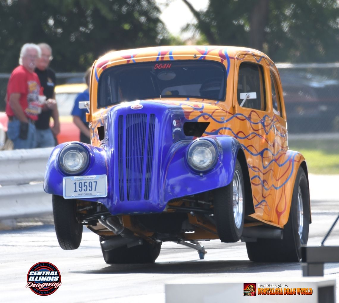 A blue and orange car with a license plate that says 19597