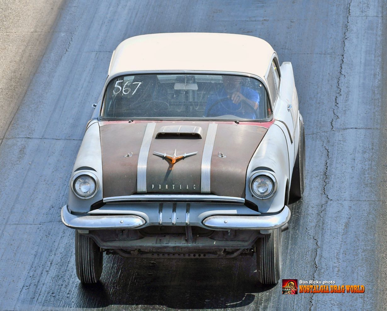 An old car with the number 567 on the windshield