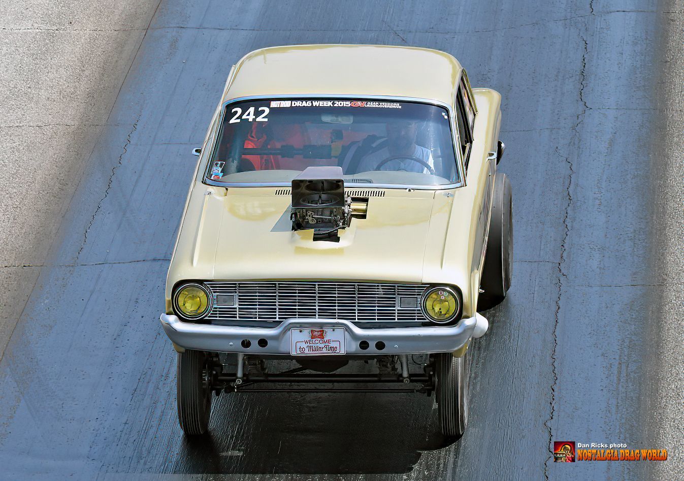 A yellow car with the number 242 on the windshield