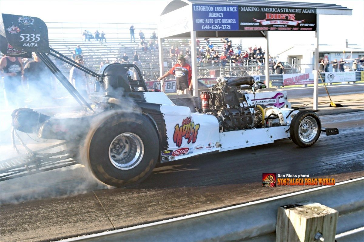 A drag race car is getting ready to race on a track.