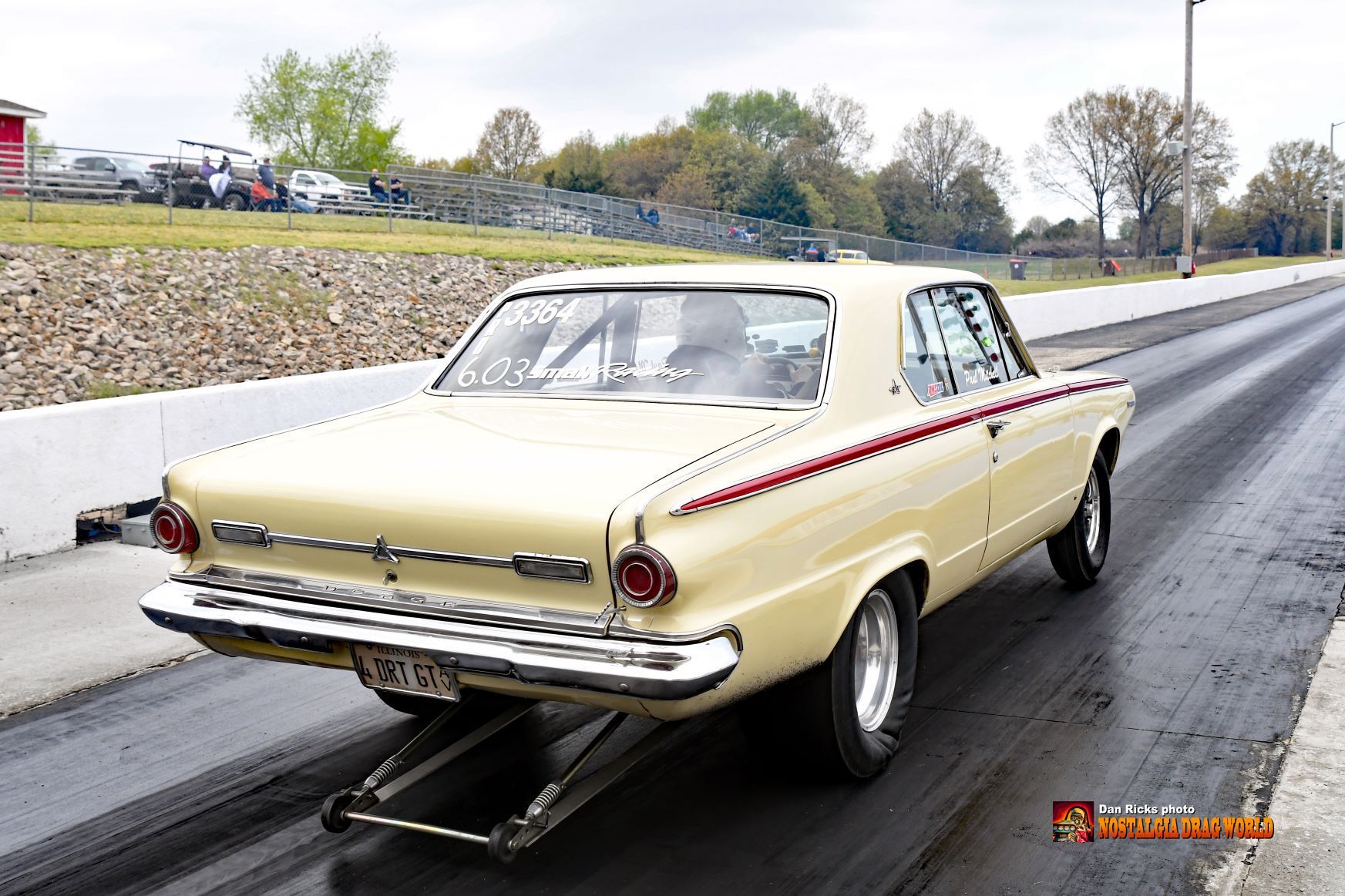 A yellow car is parked on the side of the road