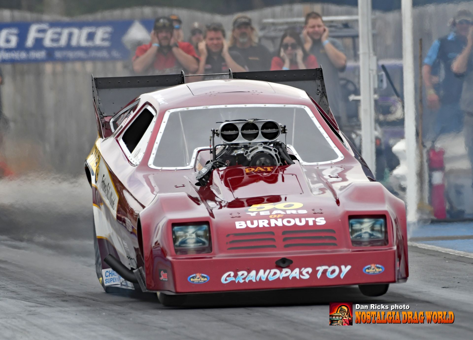 A red race car with the word grandpas toy on the side