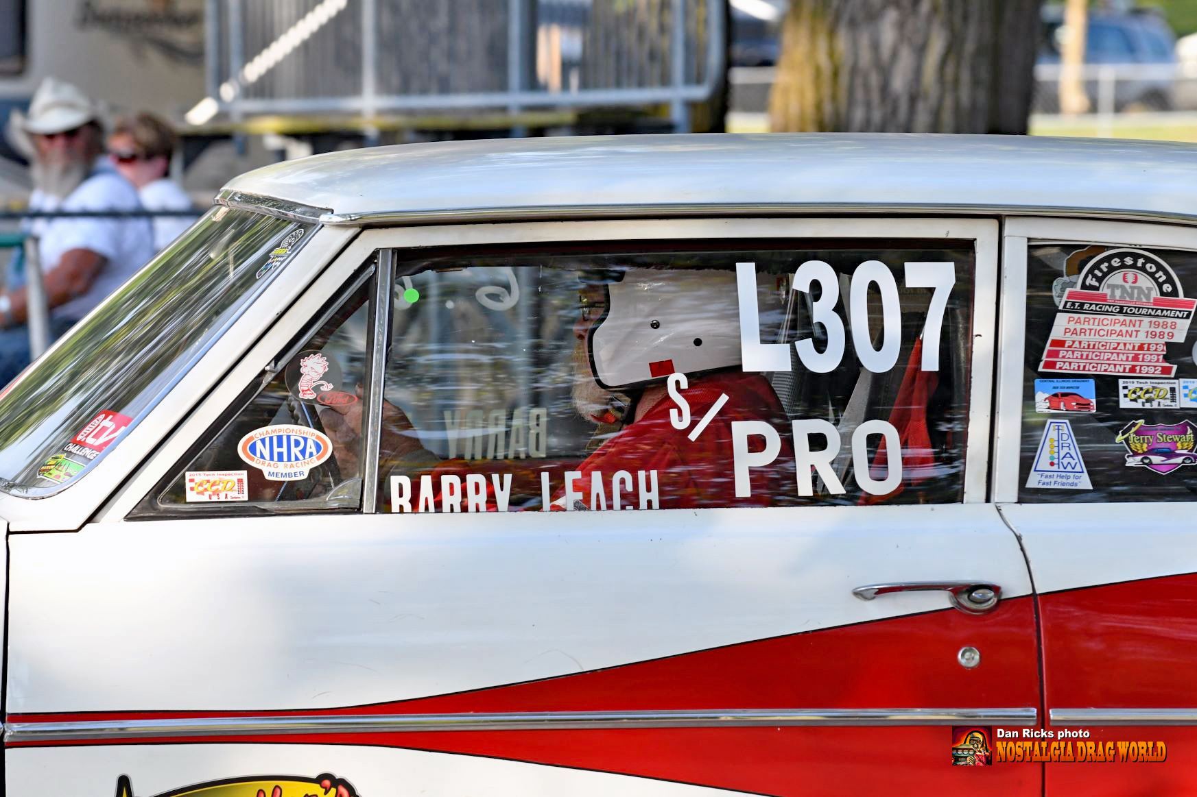 A white and red race car with the number l307 on the side.