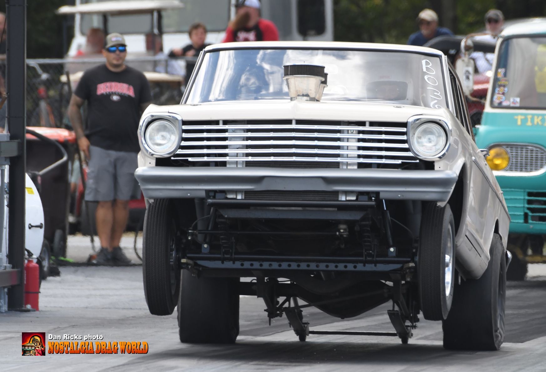 A white car is parked on the side of the road.