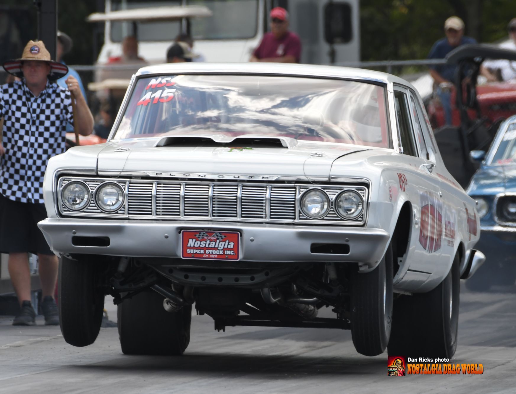 A white car with a license plate that says ' muscle car ' on it