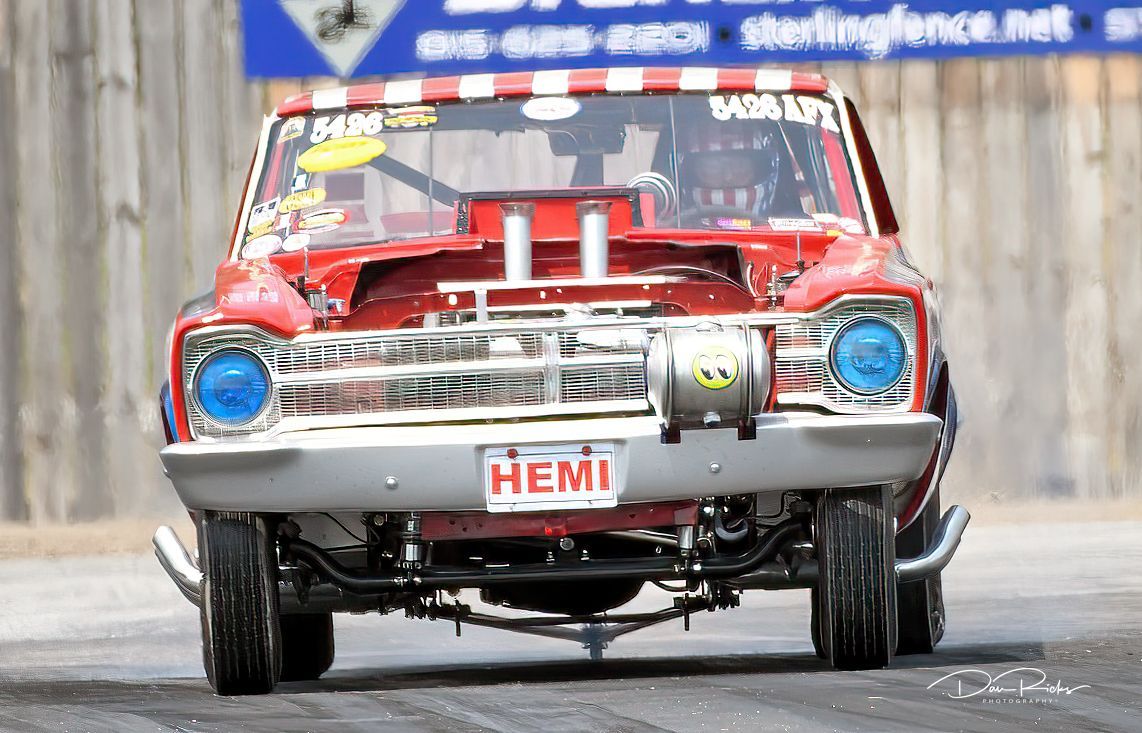 A red car with a license plate that says hemi