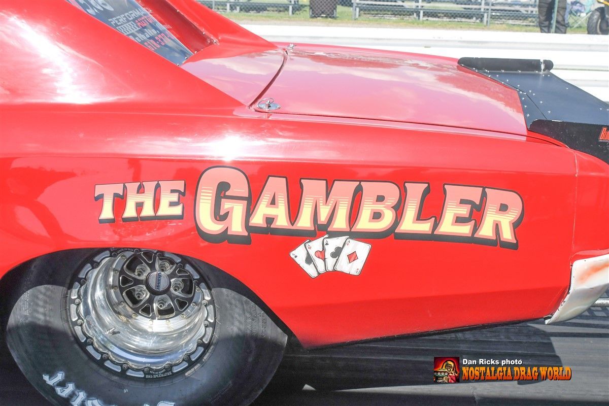 A red car with the gambler written on the side