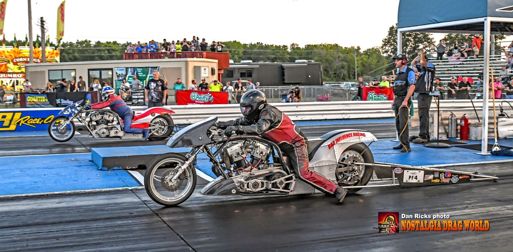 A man is riding a motorcycle on a race track.
