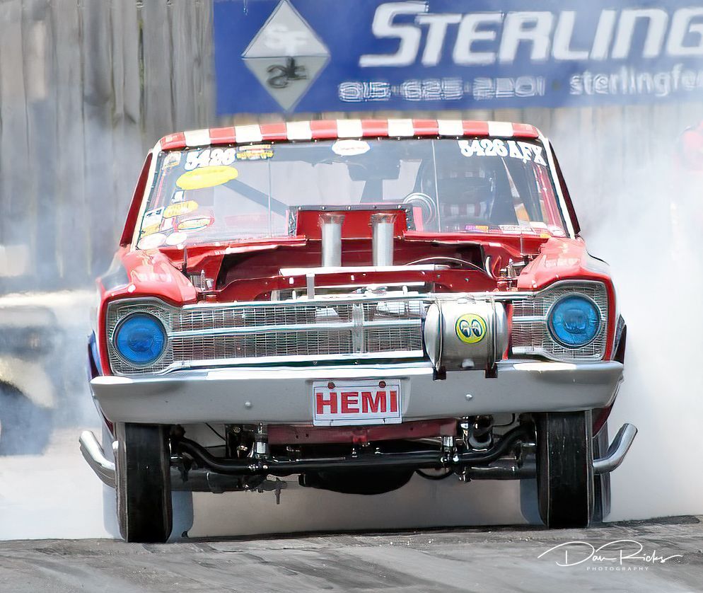 A red car with a license plate that says hemi