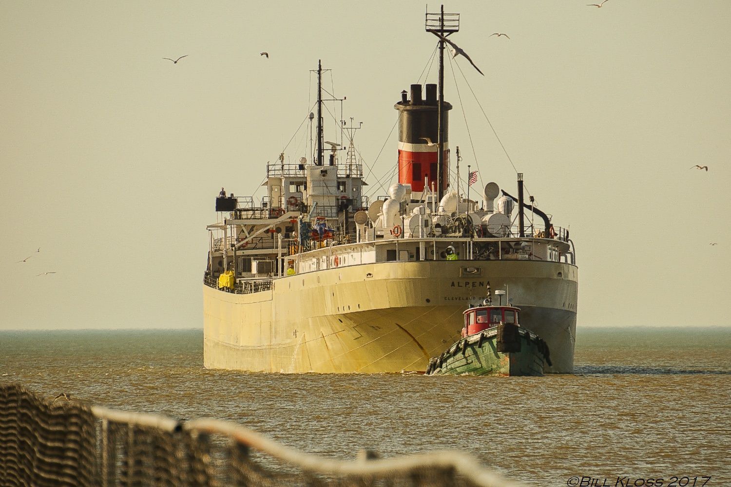 A large ship is floating on top of a body of water.