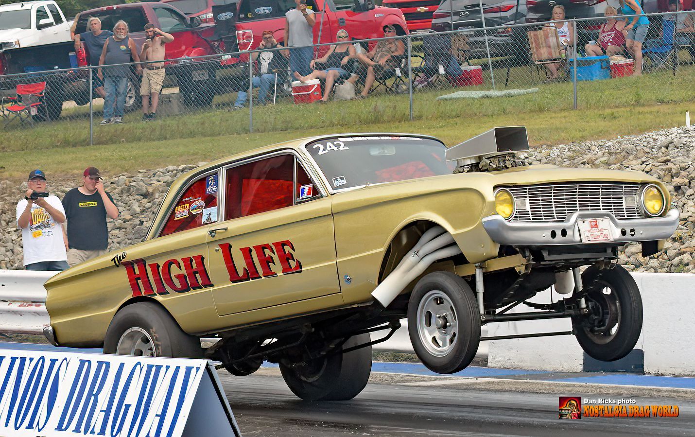 A yellow car with the word high life on it