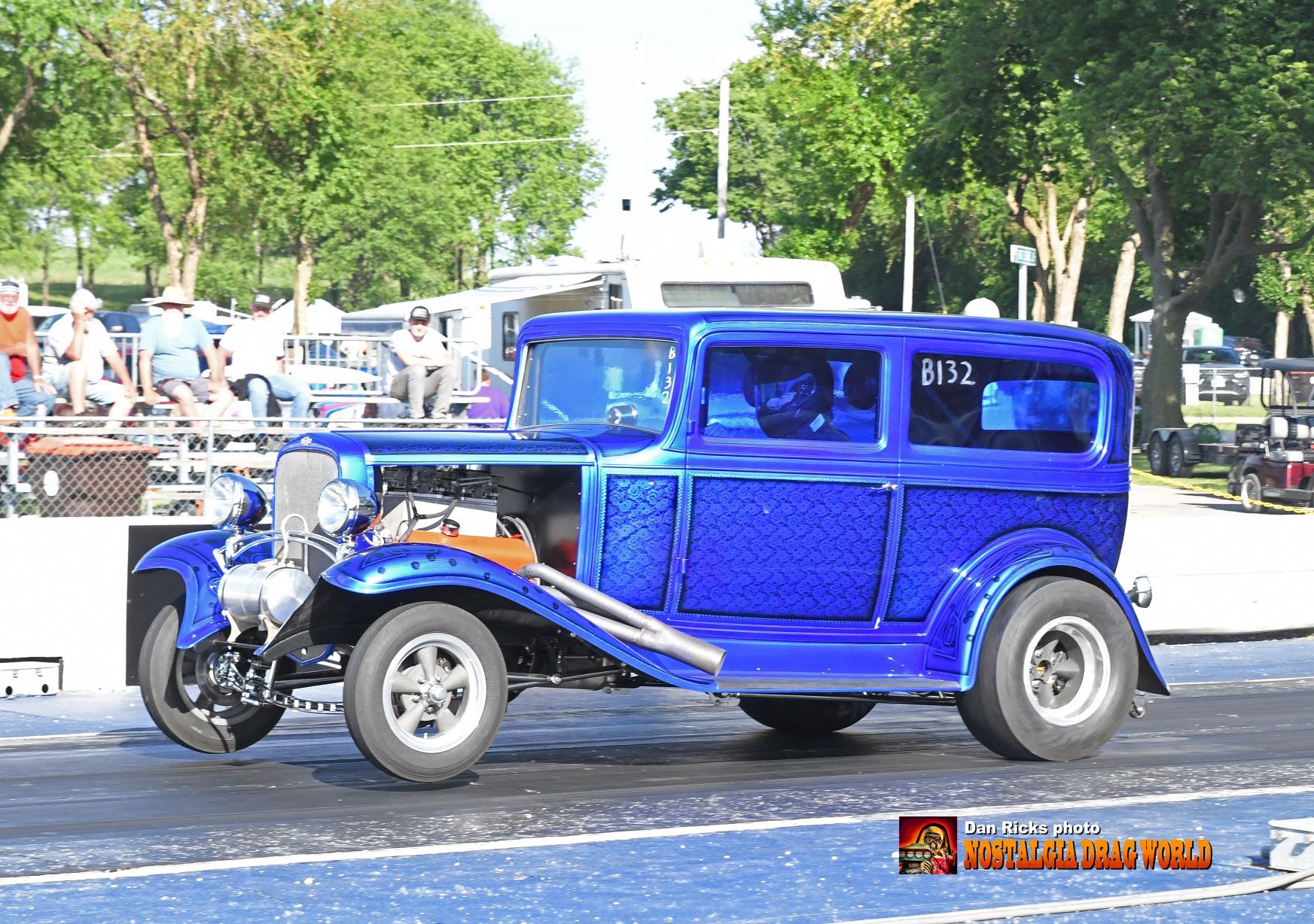 A blue car with the number 8152 on the side of it