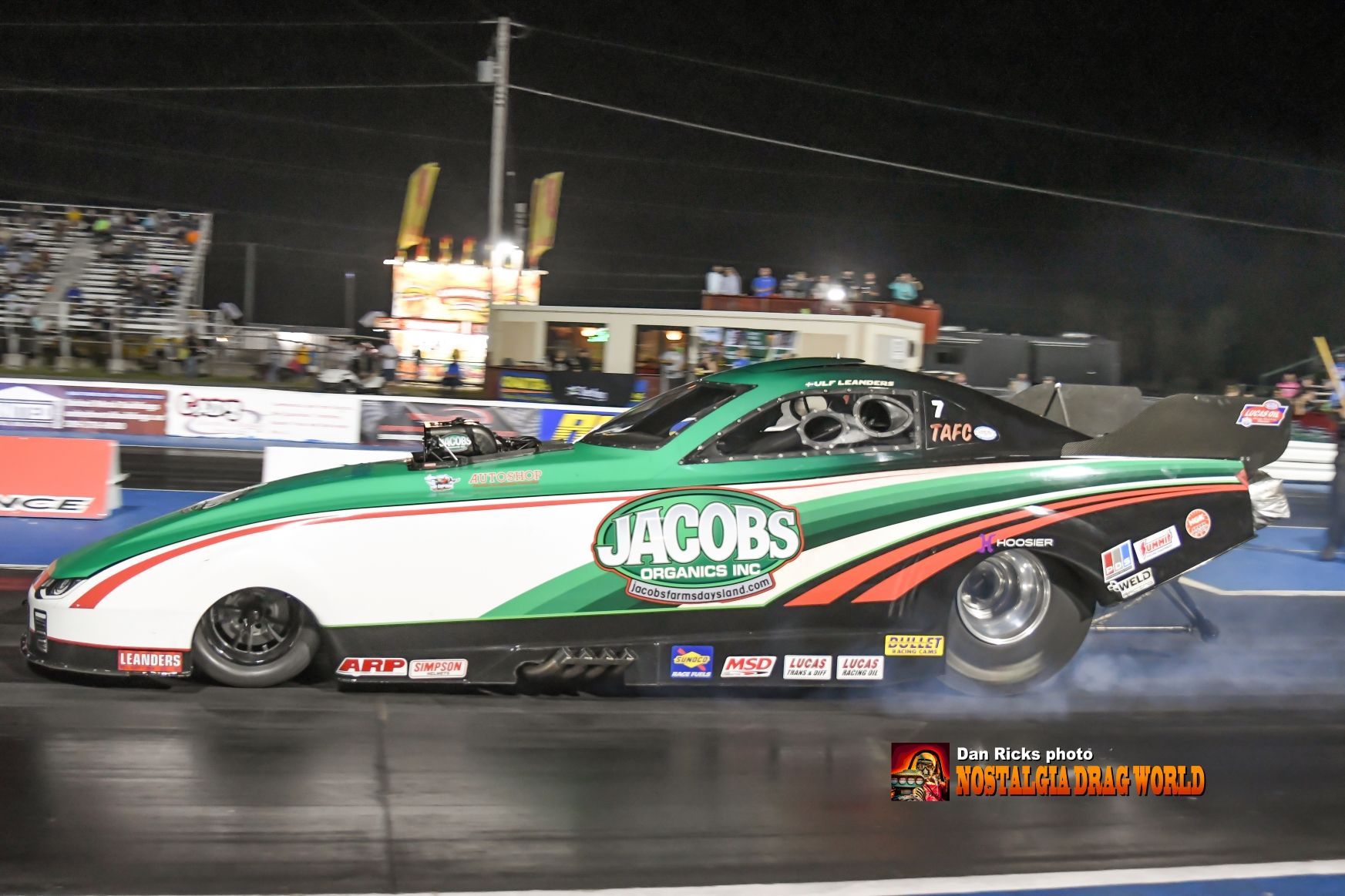 A green and white race car with the word jacobs on it