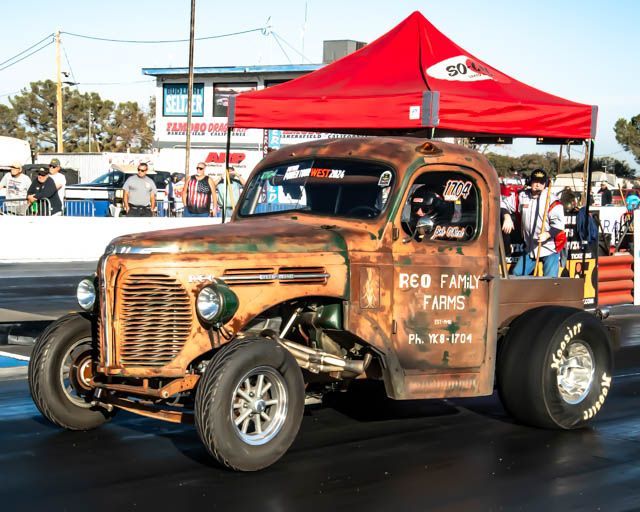 An old rusty truck with the word farms on the side