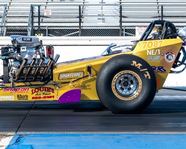 A yellow and purple race car with the number 2057 on the side