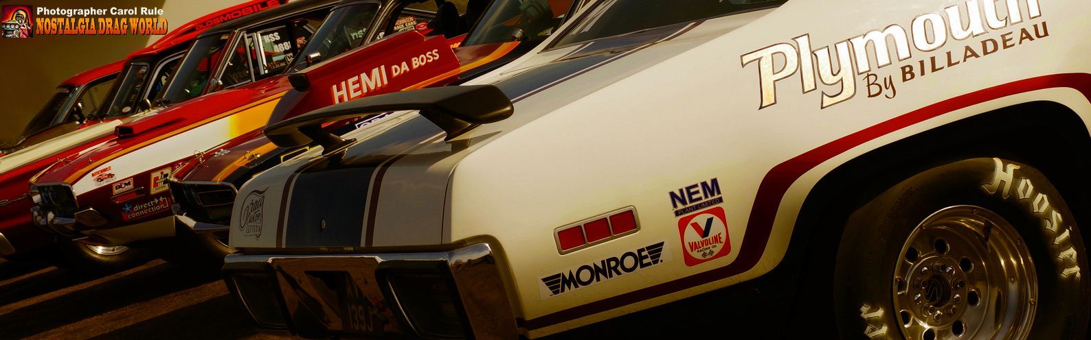 A plymouth car is parked next to another car