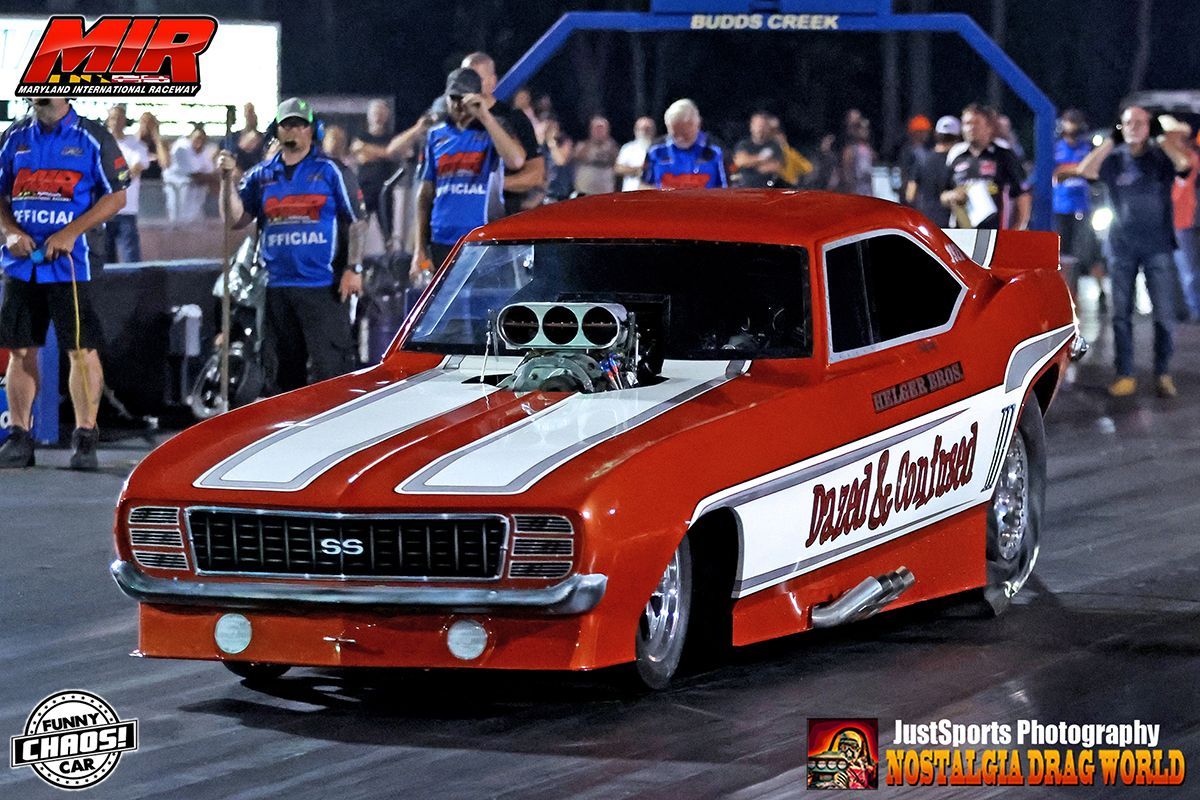 A red and white race car with the word muscle on the side