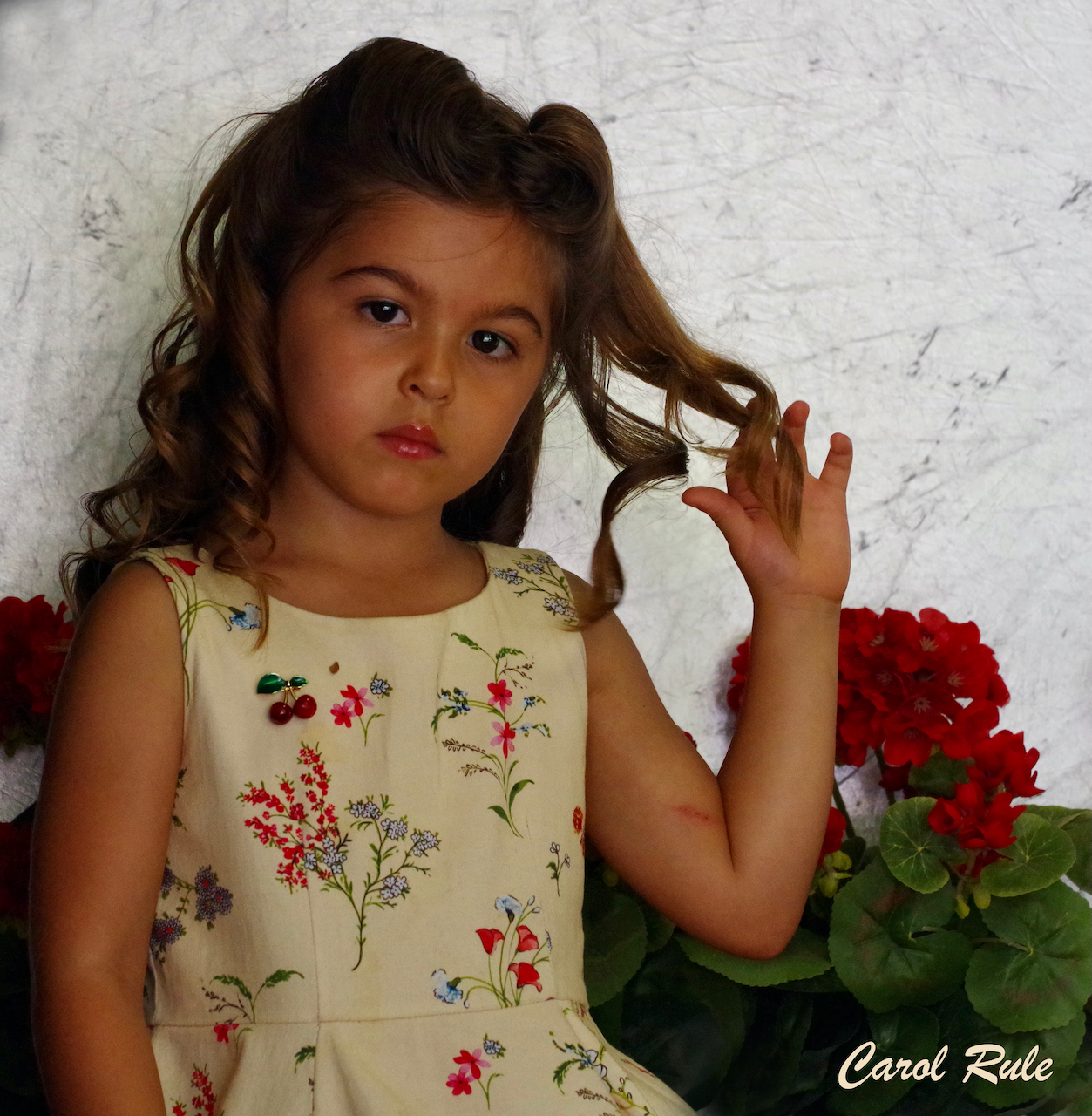 A little girl wearing a floral dress by carol rabe