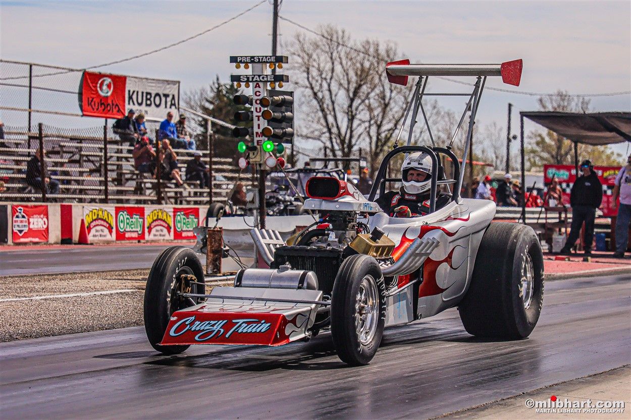 A race car is driving down a race track.