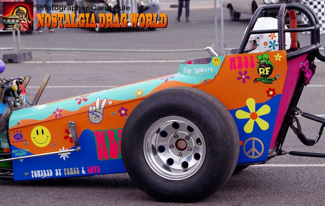 A colorful race car with a peace sign on the side