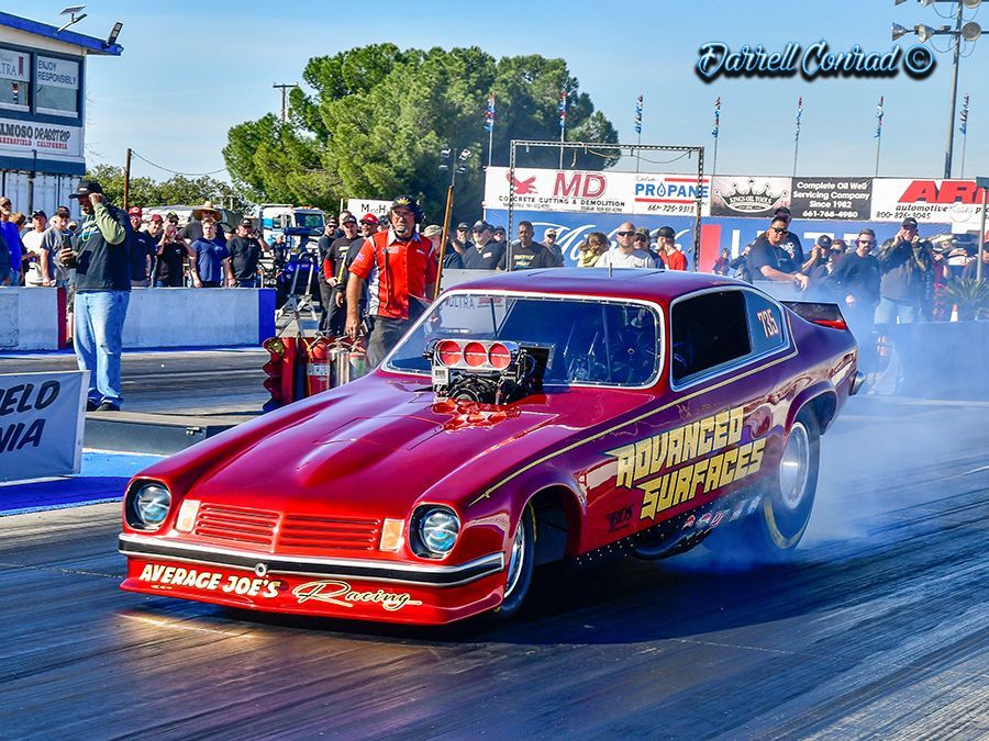 A red car with advanced surfaces written on the side