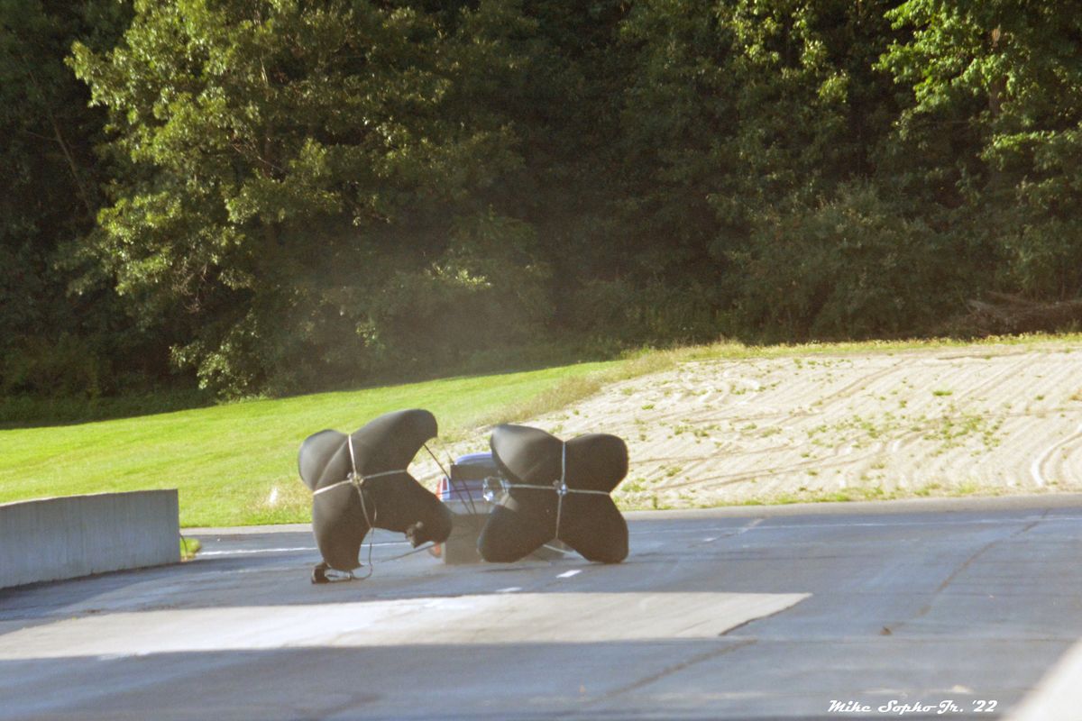 A person is laying on the ground with a blanket wrapped around them