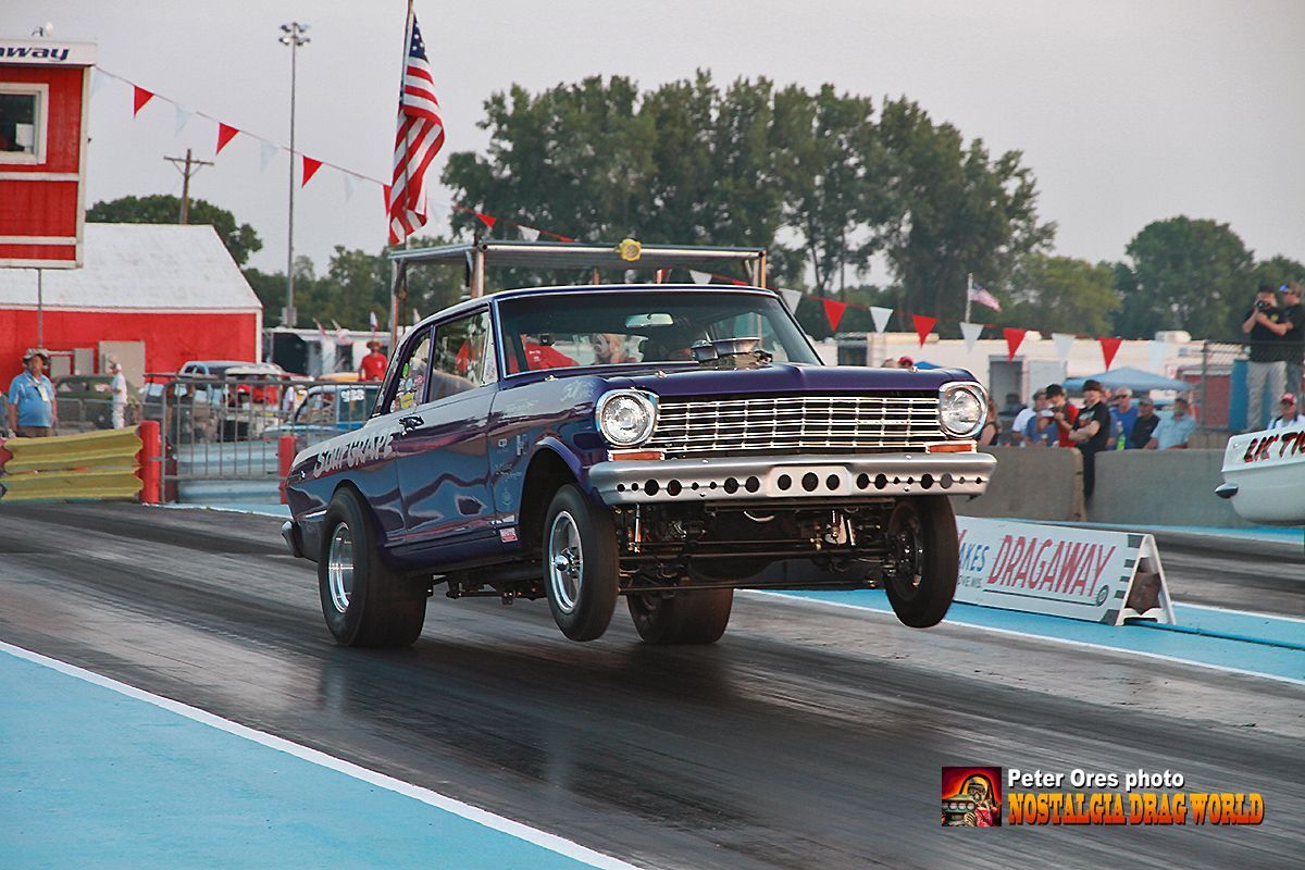 A purple car is driving down a race track.