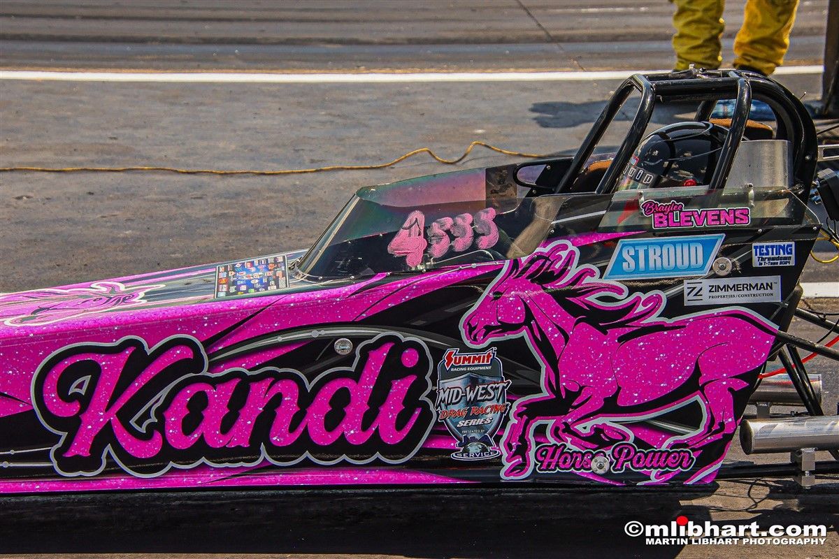 A pink race car with the name kandi on it