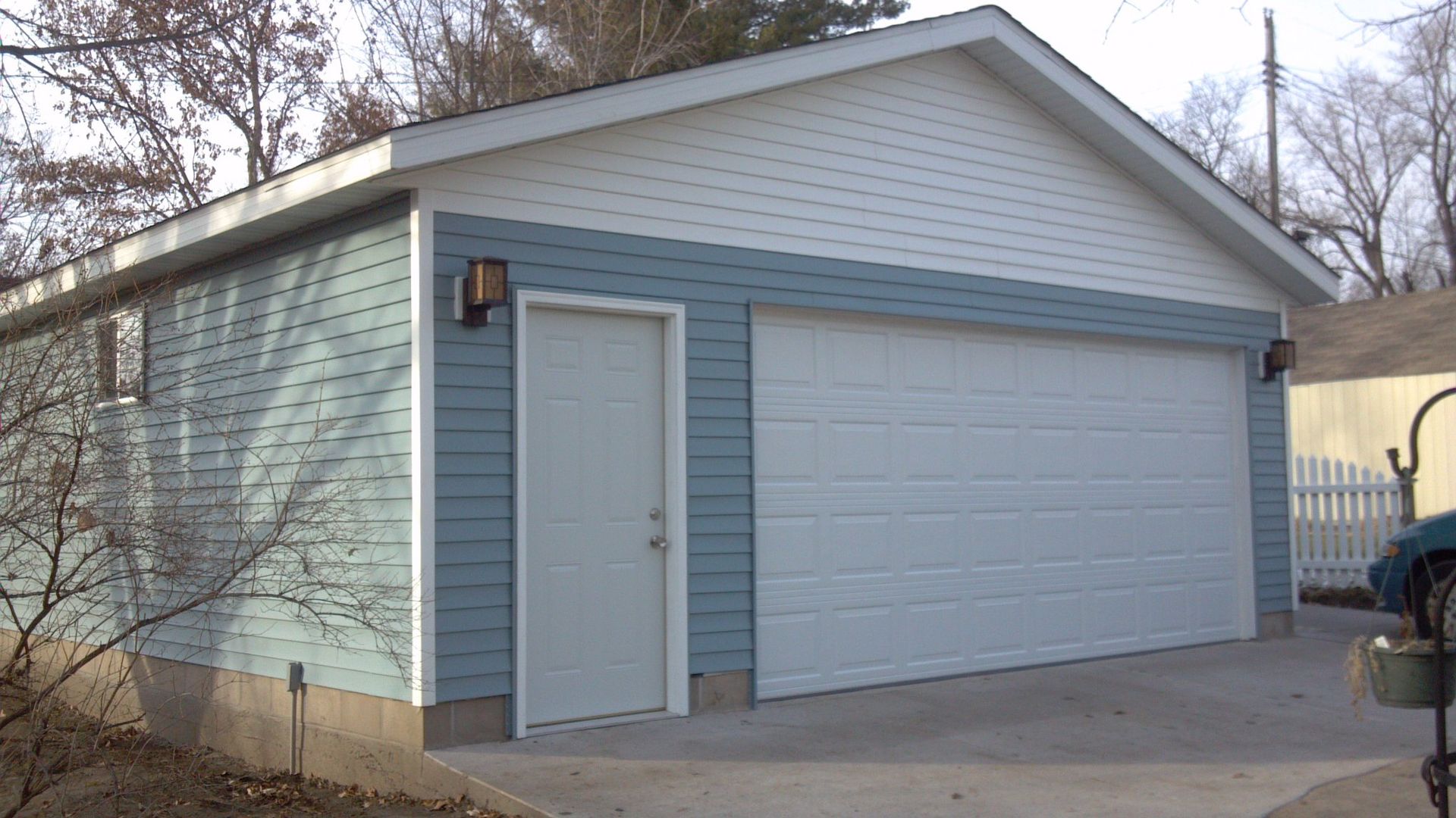 A blue and white garage with a white door