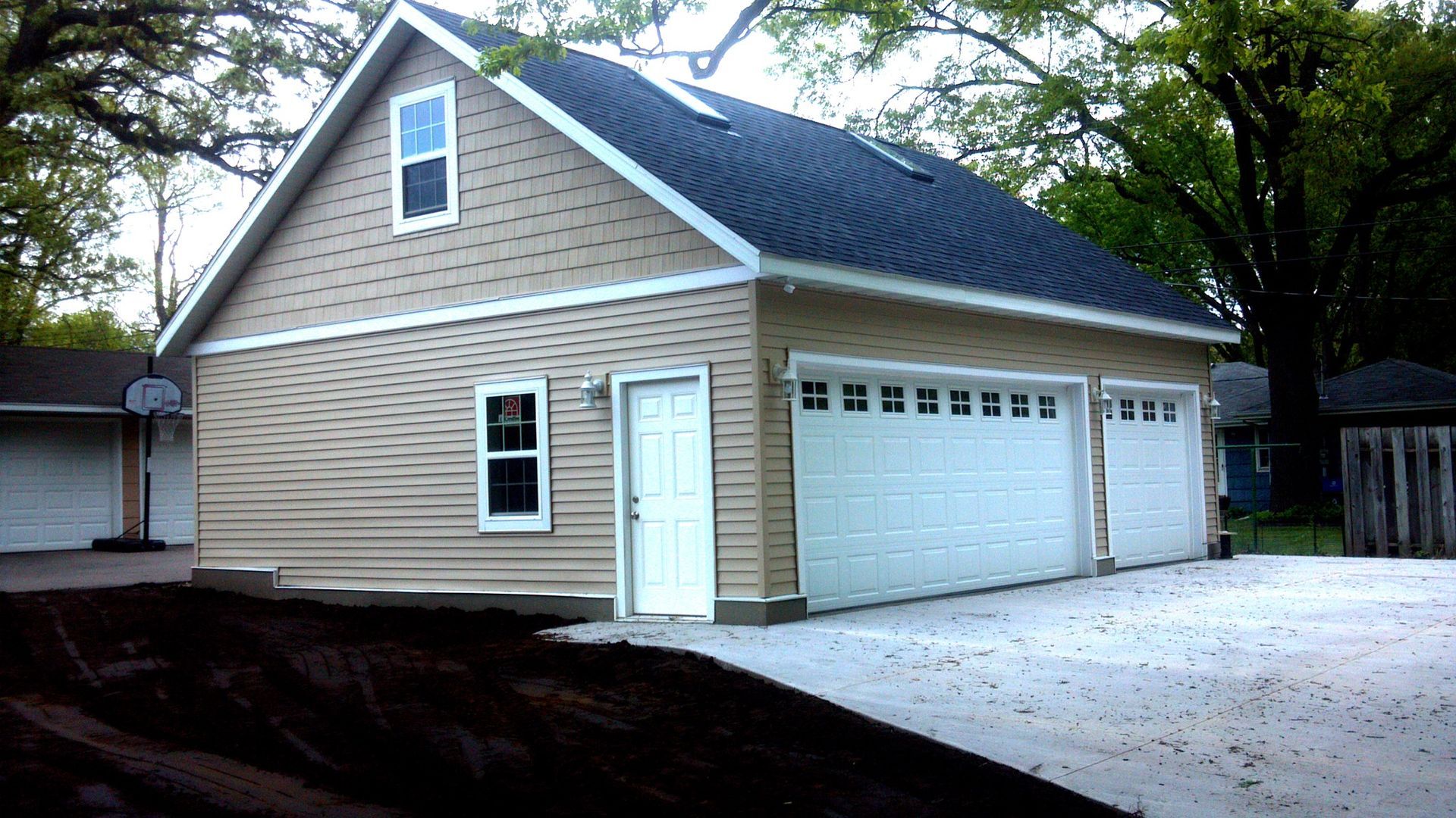 A garage with a basketball hoop in front of it