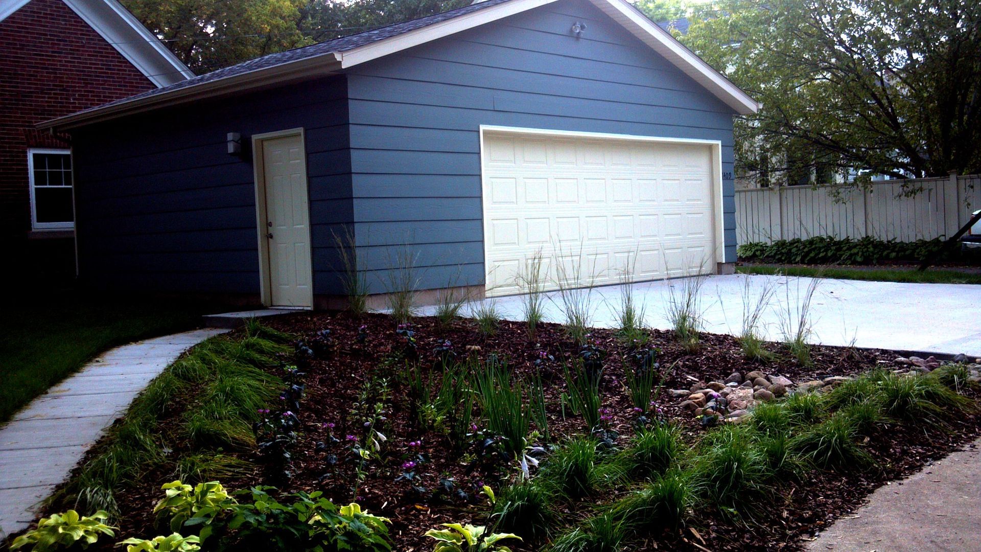A blue house with a white garage door