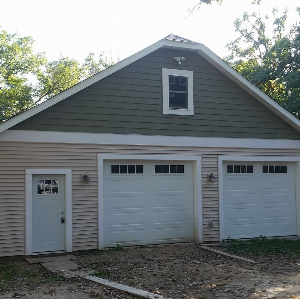 A house with three garage doors and a window