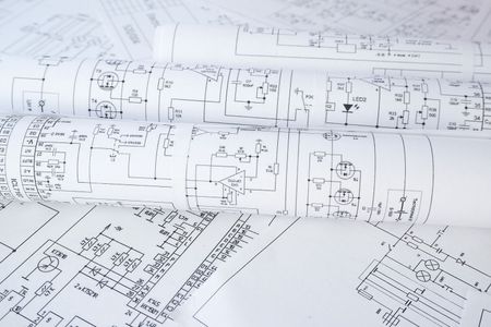 Rolled-up blueprints, schematic diagrams in black ink on white paper, suggesting technical or engineering plans.