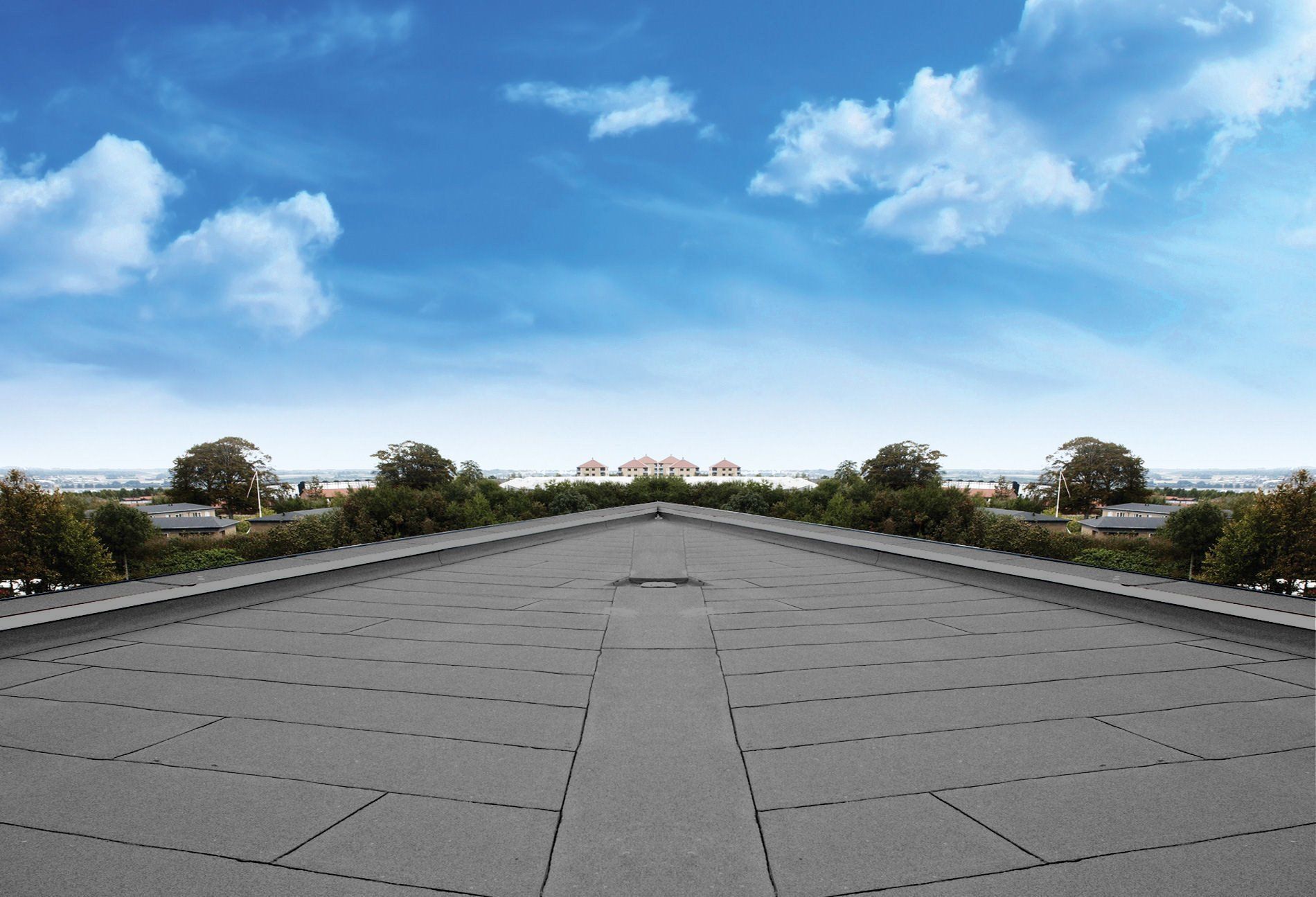 A roof with a blue sky and trees in the background
