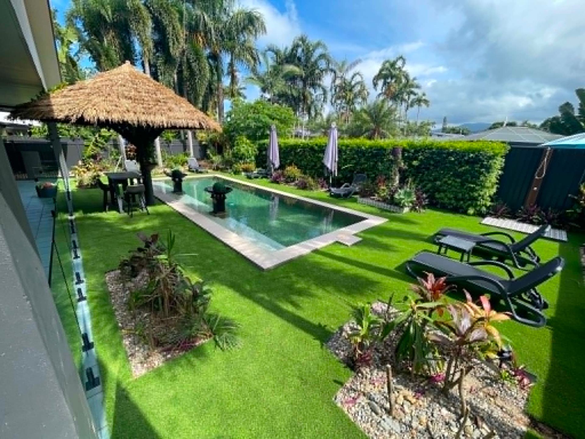 New artificial turf and planting installed to the pool area