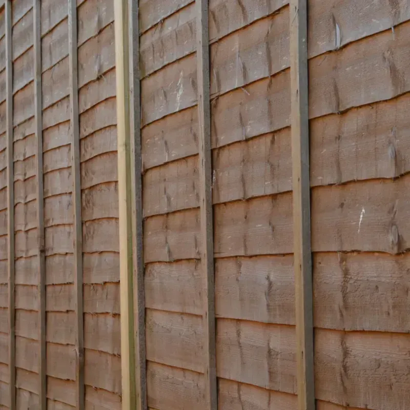 A close up of a wooden wall with a metal frame