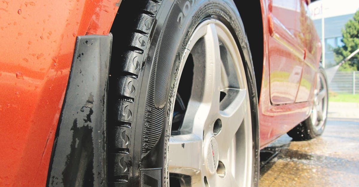 A close up of a car tire on a wet road. | Jim's Auto Service