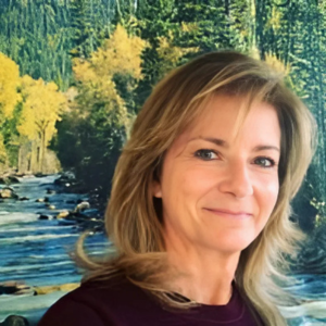 Woman with blonde hair smiles in front of a nature mural with a river and trees.