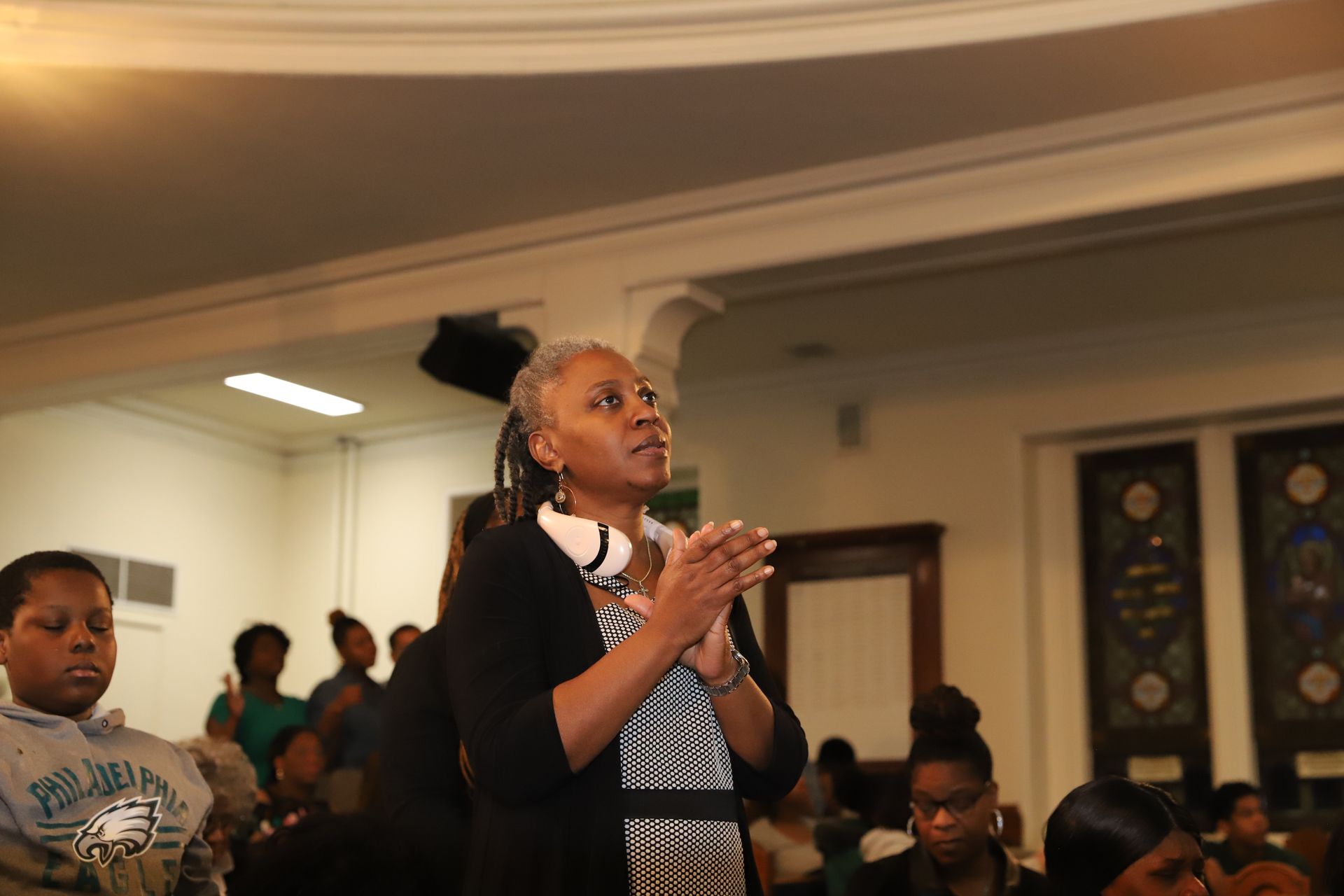 A woman is talking to a group of people in a room.