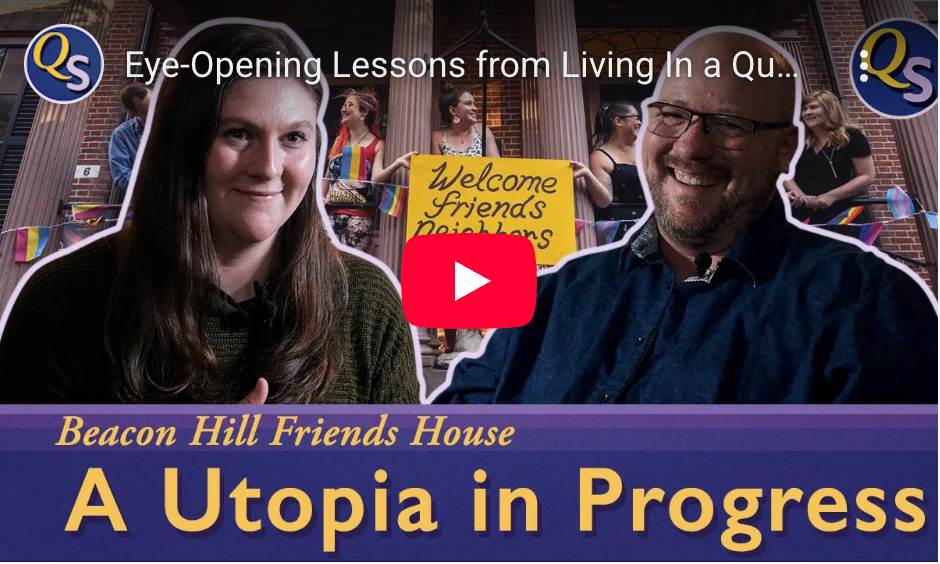 Two people smiling in front of a sign 