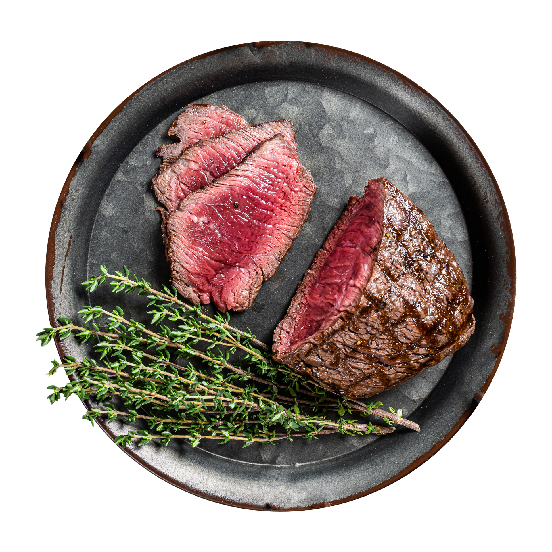 JPOT Japanese BBQ filet mignon cooked and partially sliced medium rare with herbs on a dark gray black plate  bird's eye view