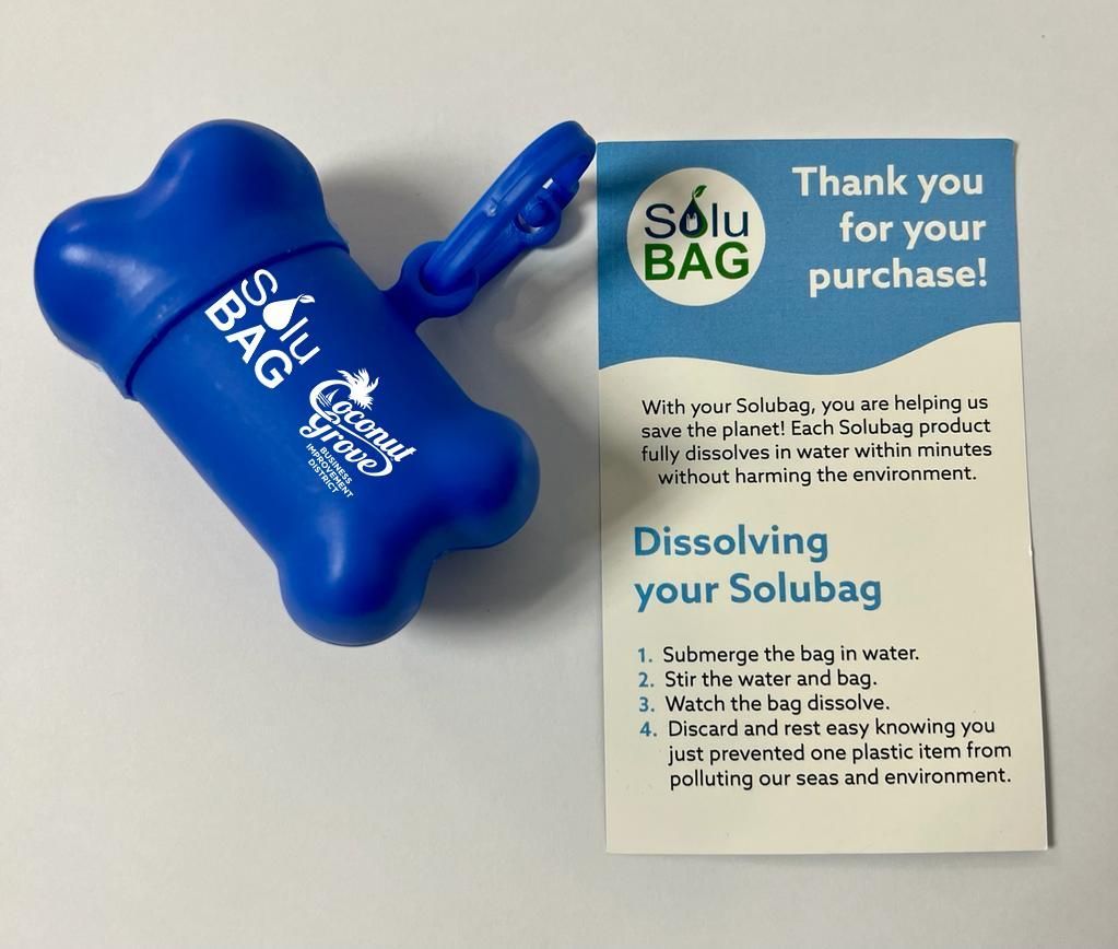 A blue bone shaped dog poop bag with a thank you for your purchase card