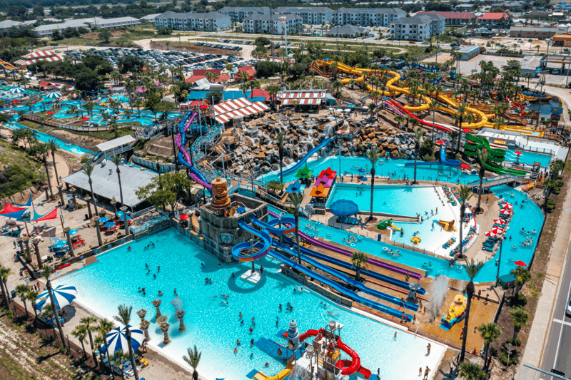 An aerial view of a water park filled with people and water slides.