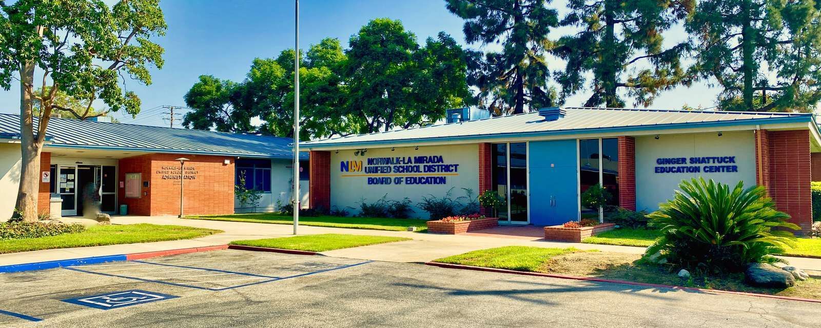 Unified School District and the Ernie B. Sotomayor Education Center, with greenery and a blue sky.