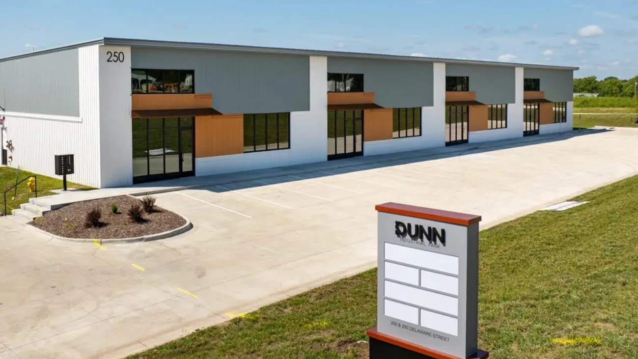 Modern industrial building with gray and white facade; 