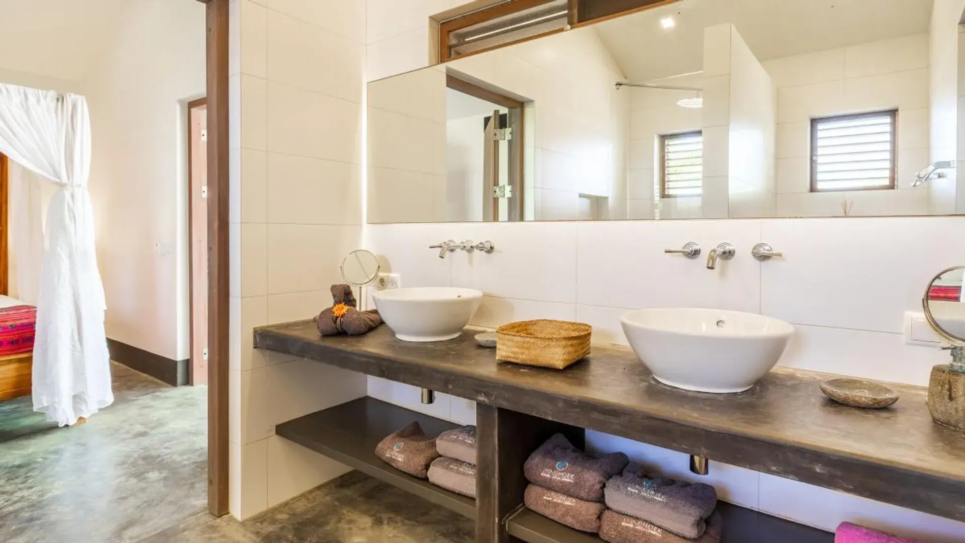 A bathroom with two sinks and a mirror.