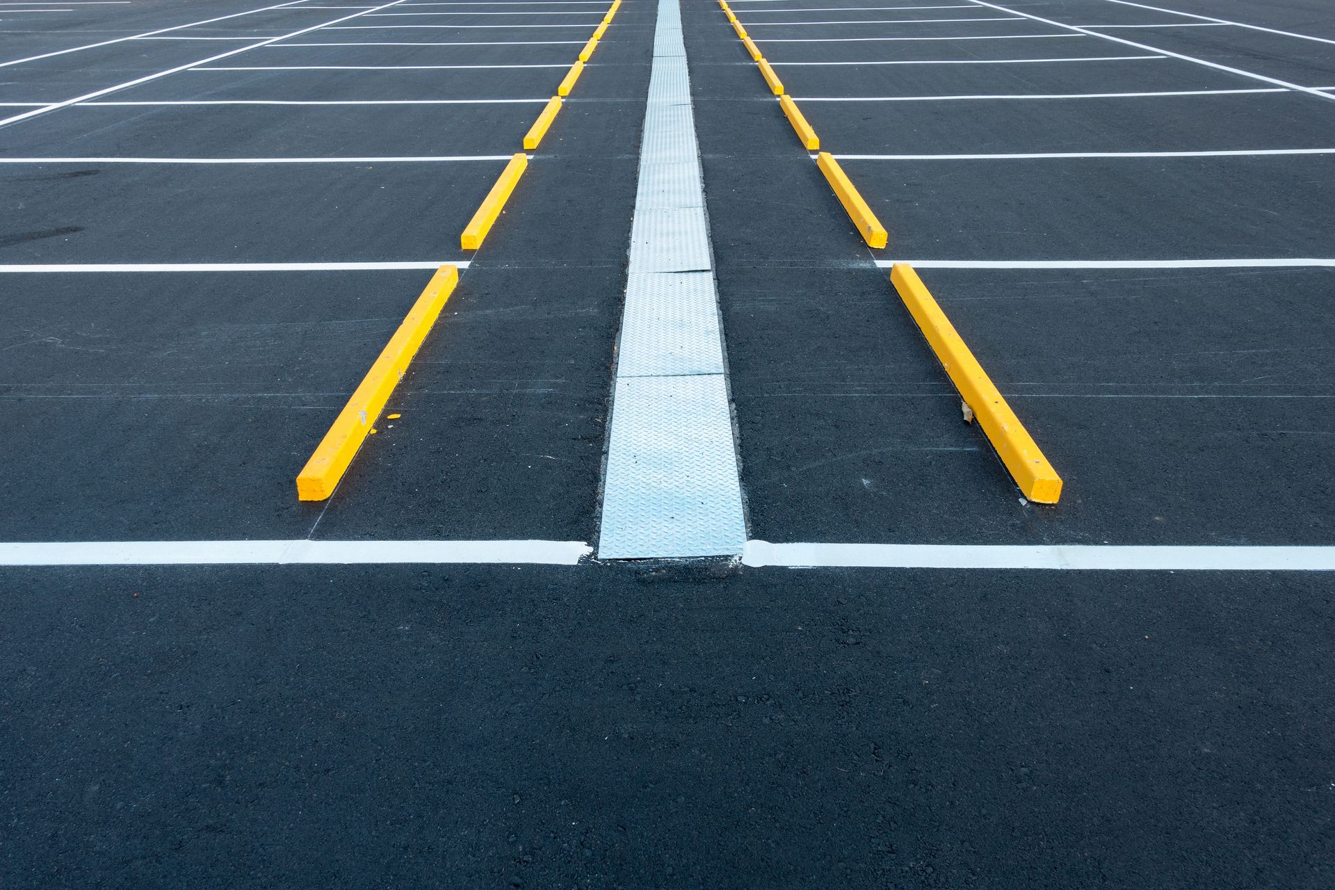 Empty parking lot with painted white and yellow parking lines